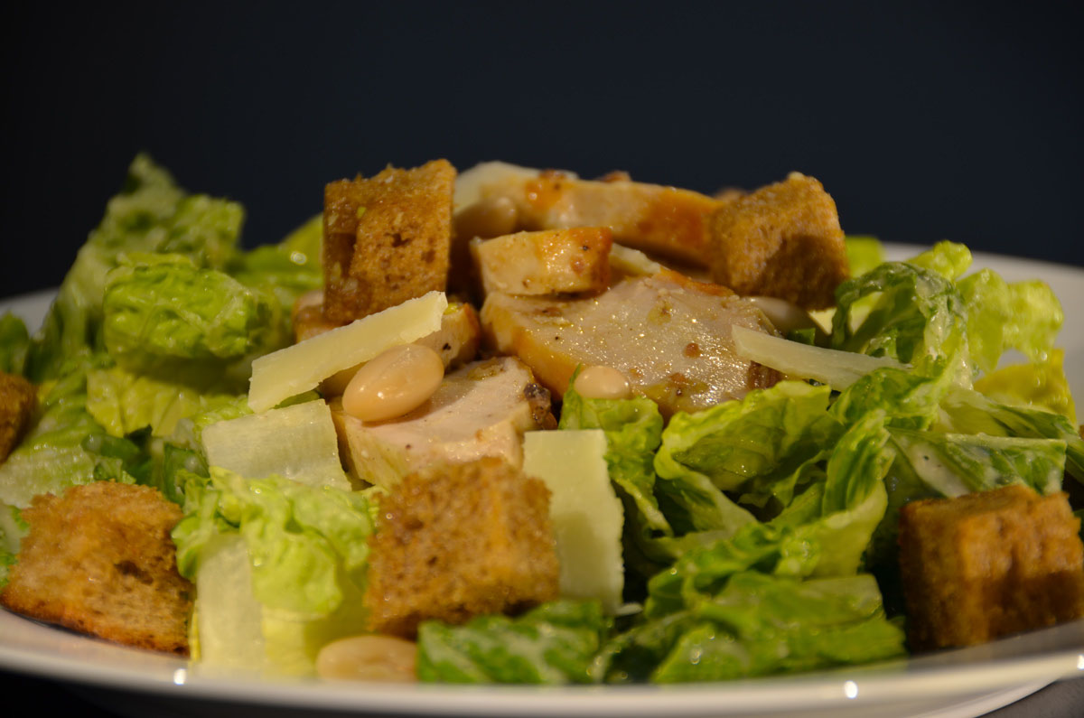 An image depicting the chicken caesar salad with cannellini bean dressing