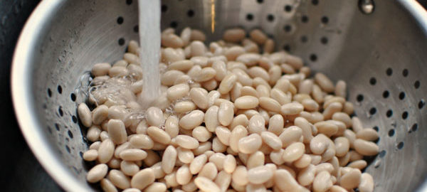 An image depicting beans being rinsed