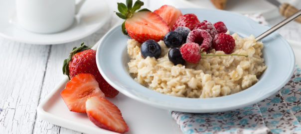 An image depicting white bean oatmeal topped with fresh fruit
